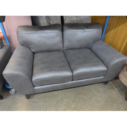 1485 - A dark grey vegan leather upholstered three seater, two seater and love seat