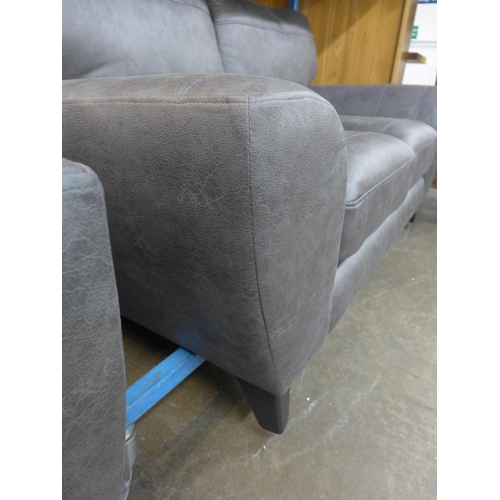 1485 - A dark grey vegan leather upholstered three seater, two seater and love seat