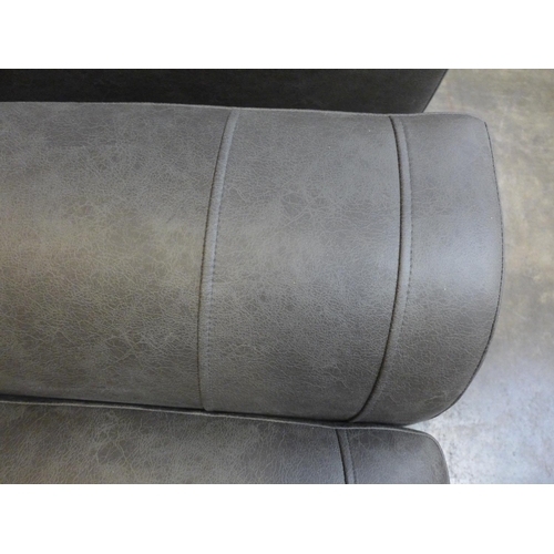 1485 - A dark grey vegan leather upholstered three seater, two seater and love seat