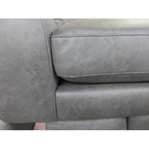 1485 - A dark grey vegan leather upholstered three seater, two seater and love seat