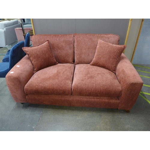 1497 - A dusty red textured velvet upholstered two seater sofa