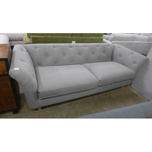 1500 - A light grey upholstered modern Chesterfield style large three seater sofa