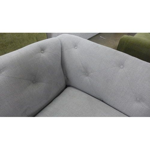 1500 - A light grey upholstered modern Chesterfield style large three seater sofa