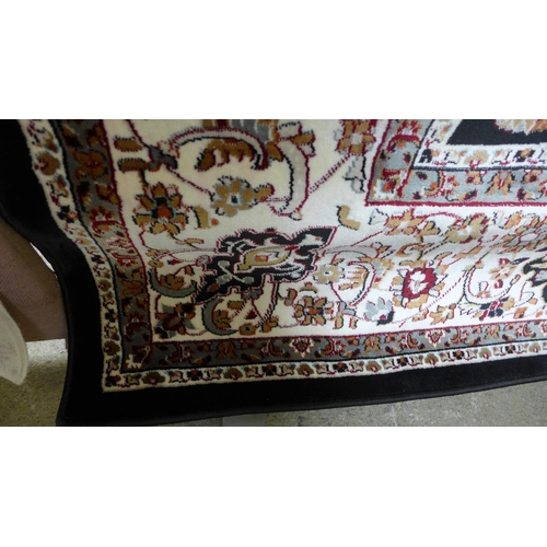 1519 - A black ground fine woven Iranian carpet with all over floral pattern