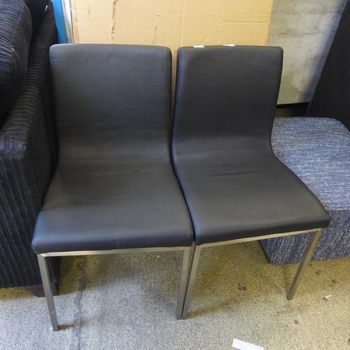 1569 - A pair of black and chrome leather effect dining chairs