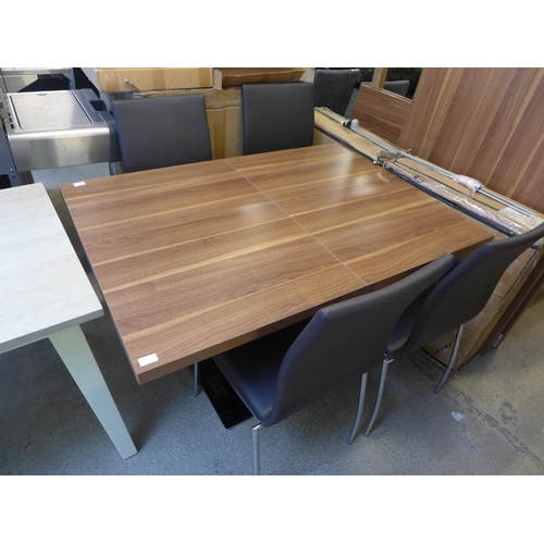 1615 - A Mark Webster walnut effect extending dining table with black base and four brown and chrome chairs