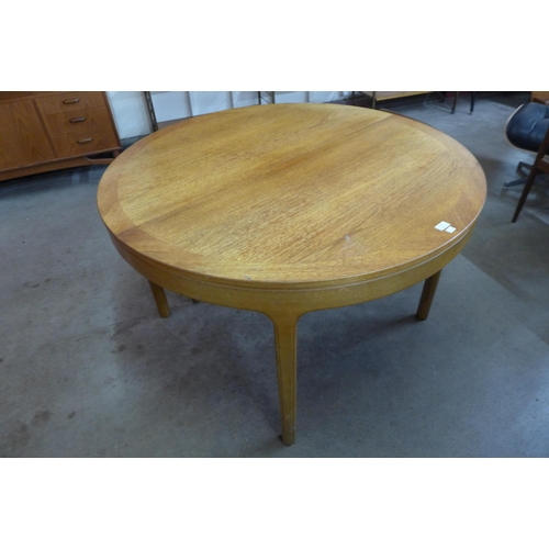 15 - A Nathan teak circular extending dining table and five chairs