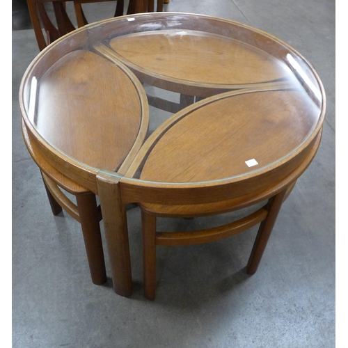 37 - A Nathan Trinity teak and glass topped circular nest of tables