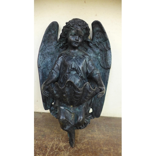 381 - A French Art Nouveau style bronze angel wall hanging water font