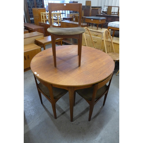 39 - A Nathan teak circular extending dining table and four chairs