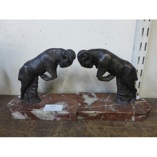 393 - A pair of spelter ram bookends, on rouge marble socles