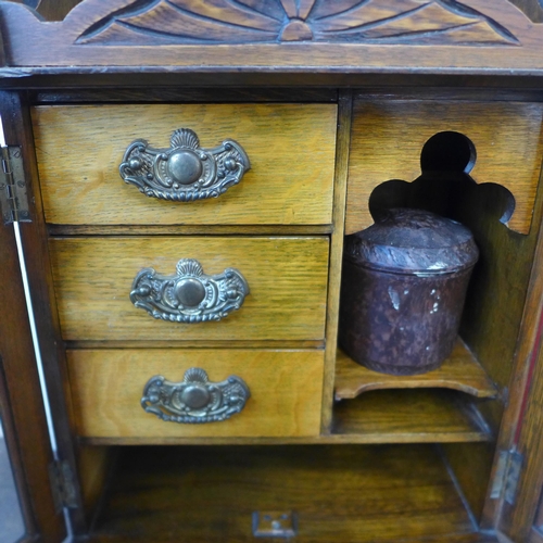 395 - A late Victorian oak wall hanging smokers cabinet