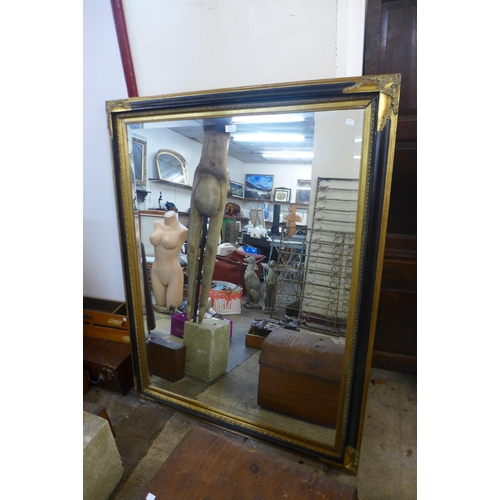 422 - A large Victorian style ebonised and parcel gilt framed mirror