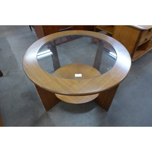 53 - A teak and glass topped circular coffee table