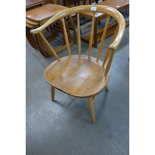 57 - An Ercol Blonde elm and beech 338 model cowhorn fireside chair