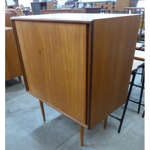 64 - A G-Plan Form-5 teak two door cabinet on stand