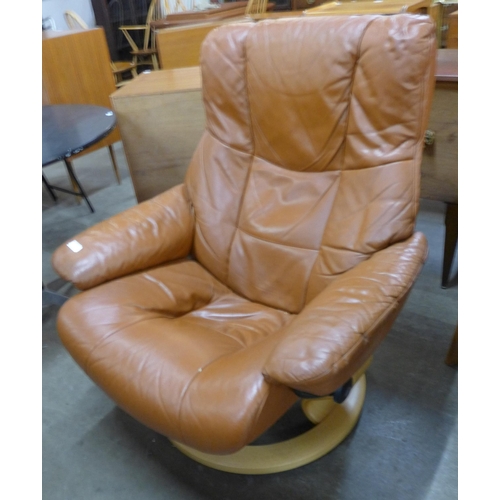 92 - A Norweigan Ekorness beech and tan leather revolving lounge chair