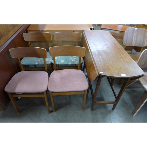 97 - A teak drop-leaf dining table and four chairs