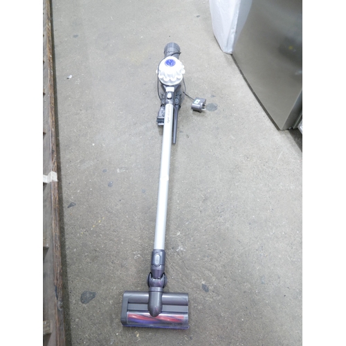 2184 - A Dyson V6 cordless stick vacuum cleaner with wall mount charger, unused battery and accessories