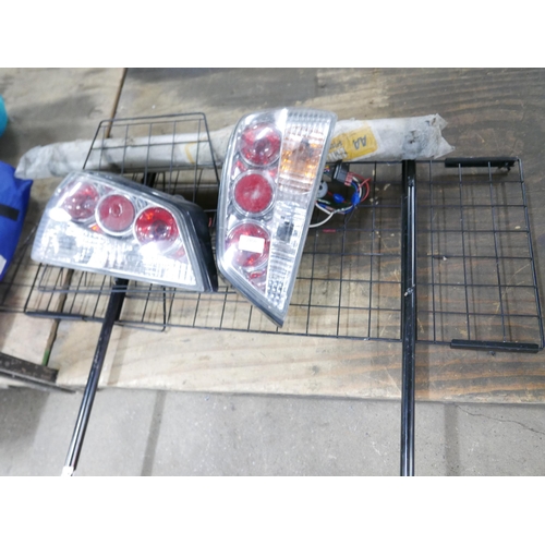 2456 - A set of Peugeot 306 rear headlights, a trailer board with power cable, a metal dog guard and an eme... 