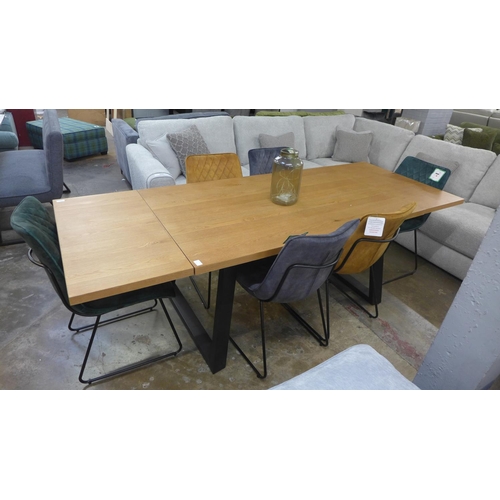 1342 - An oak 1.5m - 2.4m extending dining table with black legs and a harlequin set of six diamond stitch ... 