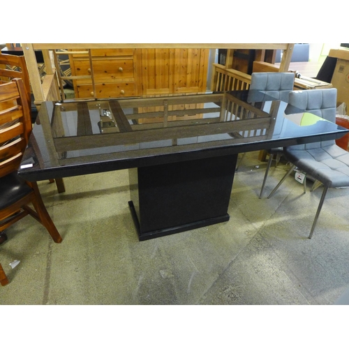 1546 - A black speckled granite effect dining table