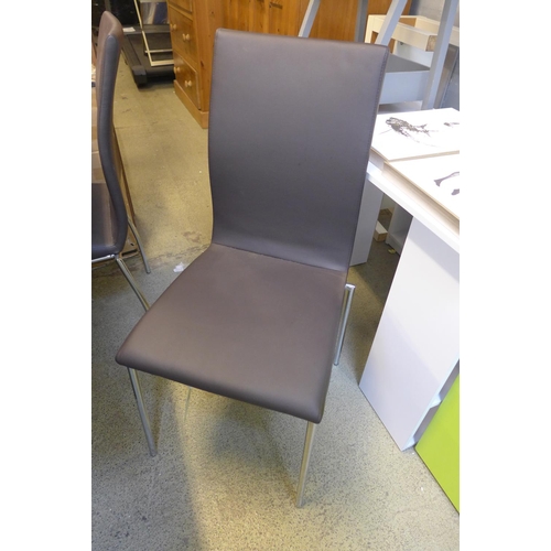 1570 - A Mark Webster walnut effect extending dining table with black base and four brown and chrome chairs