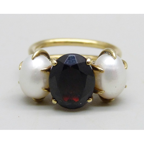 1001 - A yellow metal, garnet and egg shaped pearl ring, hand made in the Philippines, circa 1970, 6.5g, K