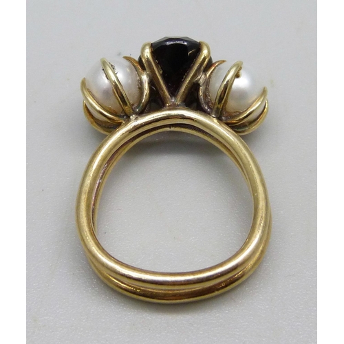 1001 - A yellow metal, garnet and egg shaped pearl ring, hand made in the Philippines, circa 1970, 6.5g, K