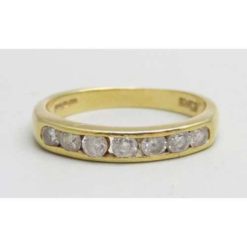 1020 - An 18ct gold channel set diamond ring, 0.5ct diamond weight, 2.8g, M