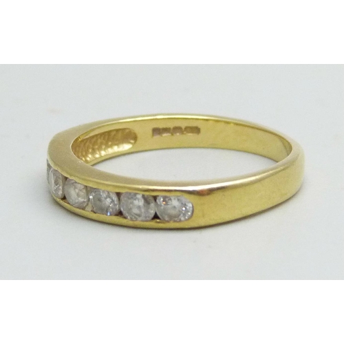 1020 - An 18ct gold channel set diamond ring, 0.5ct diamond weight, 2.8g, M