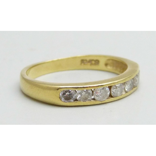 1020 - An 18ct gold channel set diamond ring, 0.5ct diamond weight, 2.8g, M