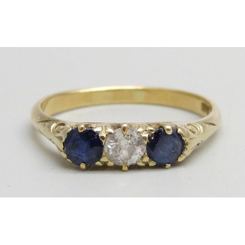 1021 - An 18ct gold, sapphire and diamond trilogy ring set with a central diamond and two sapphires, 2.5g, ... 