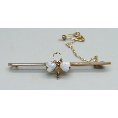 1023 - A 9ct gold bar brooch set with opals, one missing, 5cm, 3.5g