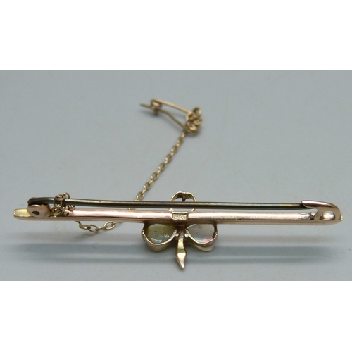 1023 - A 9ct gold bar brooch set with opals, one missing, 5cm, 3.5g