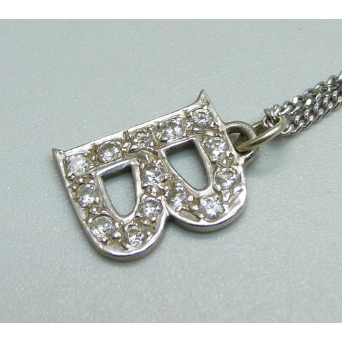 1024 - A white metal and diamond 'B' pendant on an 18ct gold chain, 5.4g and two 9ct gold 'B' pendants, 4g