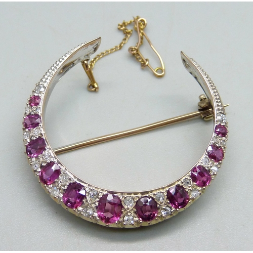 1026 - A yellow metal crescent brooch set with rubies and diamonds, 8g, 3.8cm