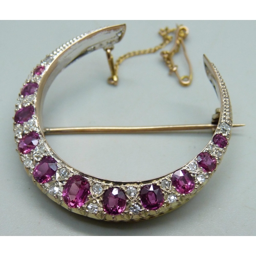 1026 - A yellow metal crescent brooch set with rubies and diamonds, 8g, 3.8cm