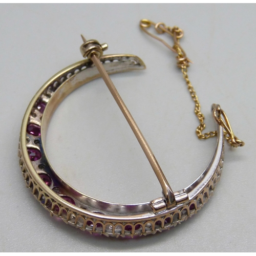 1026 - A yellow metal crescent brooch set with rubies and diamonds, 8g, 3.8cm