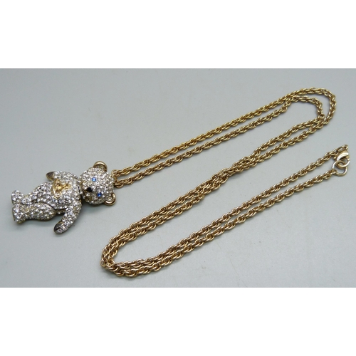 1031 - A Vivienne Westwood articulated Teddy bear pendant and chain, with pouch, (area of glue on the back ... 