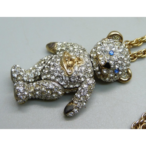 1031 - A Vivienne Westwood articulated Teddy bear pendant and chain, with pouch, (area of glue on the back ... 