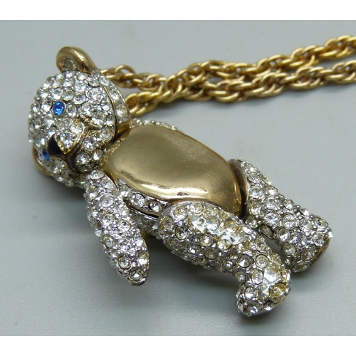 1031 - A Vivienne Westwood articulated Teddy bear pendant and chain, with pouch, (area of glue on the back ... 