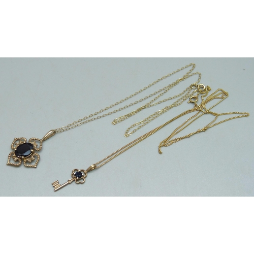 1033 - A 9ct gold pendant set with a garnet on a fine 9ct gold chain, and a 9ct gold key pendant on a 9ct g... 