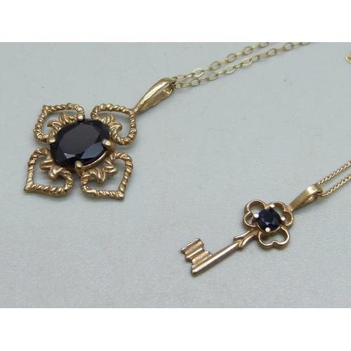 1033 - A 9ct gold pendant set with a garnet on a fine 9ct gold chain, and a 9ct gold key pendant on a 9ct g... 