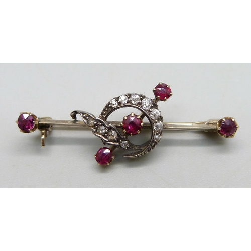 1040 - A yellow metal bar brooch with crescent design set with rubies and diamonds, 3.4g, 4cm, in associate... 