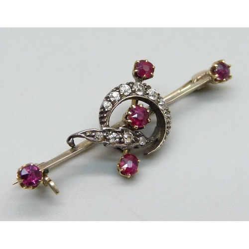 1040 - A yellow metal bar brooch with crescent design set with rubies and diamonds, 3.4g, 4cm, in associate... 