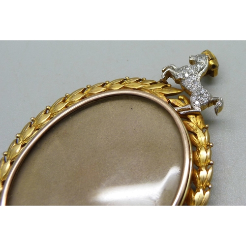 1045 - A gilt metal photograph brooch/pendant, topped with a diamond set horse and crown, 7.2cm, cased (cas... 