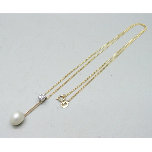 1059 - A natural saltwater pearl and diamond set in a yellow metal pendant with a white metal bail, on an 1... 