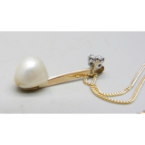 1059 - A natural saltwater pearl and diamond set in a yellow metal pendant with a white metal bail, on an 1... 