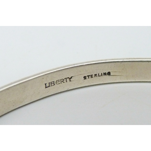 1060 - A Liberty Arts and Crafts enamel and silver bangle, marked 'Liberty' and 'Sterling', circa 1910, 23g... 